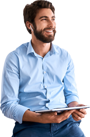 Smiling man with ear pods using touch screen tablet.
